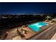 Tranquil pool with integrated water feature provides a serene escape with stunning city views under the night sky at 2858 Red Arrow Dr, Las Vegas, NV 89135