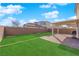 This backyard is the ideal size with a covered patio, well-maintained lawn and a brick privacy fence at 2865 Victorian Rd, North Las Vegas, NV 89086