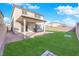 The backyard features a well-maintained lawn, a covered patio and a brick privacy fence at 2865 Victorian Rd, North Las Vegas, NV 89086