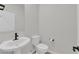 Elegant powder room with a pedestal sink and modern fixtures at 2865 Victorian Rd, North Las Vegas, NV 89086