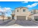 Inviting two-story home with desert landscaping, a two-car garage and a covered front entryway at 2865 Victorian Rd, North Las Vegas, NV 89086