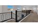 Upstairs hallway featuring modern railings, plush carpet, and abundant natural light at 2865 Victorian Rd, North Las Vegas, NV 89086