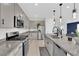 Open-concept kitchen with stainless steel appliances, granite counters, and seamless flow to the living area at 2865 Victorian Rd, North Las Vegas, NV 89086