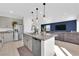Modern kitchen featuring stainless steel appliances, granite countertops, and an open layout to the living room at 2865 Victorian Rd, North Las Vegas, NV 89086