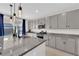 Modern kitchen with granite countertops, gray cabinetry, and stainless steel appliances at 2865 Victorian Rd, North Las Vegas, NV 89086