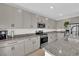 Bright kitchen with granite countertops, stainless steel appliances, and ample cabinet storage at 2865 Victorian Rd, North Las Vegas, NV 89086