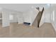 Bright living room with wood floors, a staircase, and seamless flow into the kitchen and front door at 2865 Victorian Rd, North Las Vegas, NV 89086