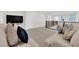 Upstairs living room featuring a comfortable couch with pillows, a metal staircase and a flat screen TV at 2865 Victorian Rd, North Las Vegas, NV 89086