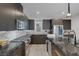 Close-up of a modern kitchen with stainless steel appliances, marble backsplash, and wooden floors at 3206 Fountaintree Ave, Henderson, NV 89044