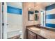 Bathroom featuring granite counters, framed mirror, and shower-tub combo at 336 S Milan St, Henderson, NV 89015