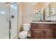 Modern bathroom with a glass-enclosed shower, toilet, and vanity with granite countertop at 336 S Milan St, Henderson, NV 89015