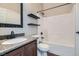 Bathroom featuring a tub/shower combination and vanity with granite countertop at 336 S Milan St, Henderson, NV 89015