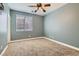 Bedroom with neutral paint, ceiling fan, window with blinds, and carpet at 336 S Milan St, Henderson, NV 89015