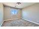 Bedroom with carpet, ceiling fan, and one window with backyard views at 336 S Milan St, Henderson, NV 89015