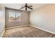Comfortable bedroom with neutral paint, carpet and a large window for natural light at 336 S Milan St, Henderson, NV 89015