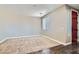 Neutral bedroom with carpet flooring, a window, and a view of the front door at 336 S Milan St, Henderson, NV 89015