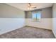 Comfortable bedroom featuring neutral paint, updated ceiling fan and a large window at 336 S Milan St, Henderson, NV 89015