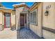 Charming front entrance with stone accents, a dark wood door, and a decorative lantern at 336 S Milan St, Henderson, NV 89015