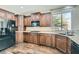 Bright kitchen featuring wooden cabinets, granite countertops, stainless steel refrigerator, and undermount sink at 336 S Milan St, Henderson, NV 89015