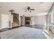 Open-concept living area with staircase, ceiling fan, carpet, and view to kitchen at 336 S Milan St, Henderson, NV 89015