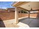 An expansive backyard with concrete slab, brick wall, and stucco-covered pillars at 341 Grapevine Rd, Mesquite, NV 89027