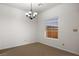 Dining area with tile flooring, window, and classic chandelier at 341 Grapevine Rd, Mesquite, NV 89027