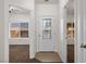 Inviting entryway featuring a decorative glass front door and views into adjacent carpeted rooms with natural light at 341 Grapevine Rd, Mesquite, NV 89027