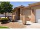 Tan stucco home with a small gated front yard and tidy landscaping at 341 Grapevine Rd, Mesquite, NV 89027