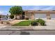 Single-story home with a two-car garage and desert landscaping at 341 Grapevine Rd, Mesquite, NV 89027