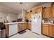 Bright kitchen featuring wood cabinets, white appliances, and spacious countertops at 341 Grapevine Rd, Mesquite, NV 89027