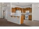 Kitchen features breakfast bar, white appliances, and wood cabinets at 341 Grapevine Rd, Mesquite, NV 89027