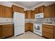 Efficient kitchen featuring tile flooring, oak cabinets, and modern white appliances at 341 Grapevine Rd, Mesquite, NV 89027