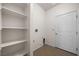 Functional laundry room with built-in shelving and a door leading to additional storage or utility space at 341 Grapevine Rd, Mesquite, NV 89027
