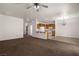Open-concept living room with carpeted floors, seamlessly connects to the kitchen area at 341 Grapevine Rd, Mesquite, NV 89027