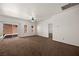 Spacious living room with carpeted floor, ceiling fan, and sliding glass door to the backyard at 341 Grapevine Rd, Mesquite, NV 89027