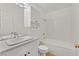 All white bathroom featuring a tub-shower, tiled walls, and sleek vanity at 3672 Angela Robin St # 206, Las Vegas, NV 89129