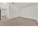 Inviting bedroom with neutral carpet leading to a hallway and door at 3672 Angela Robin St # 206, Las Vegas, NV 89129