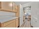 Bright kitchen features light wood cabinetry, white appliances, and wood-look flooring at 3672 Angela Robin St # 206, Las Vegas, NV 89129