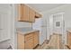 Cozy kitchen featuring light wood cabinets, gray countertops, and wood-look flooring at 3672 Angela Robin St # 206, Las Vegas, NV 89129