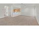 Open-concept living room with a breakfast bar, carpet, and ceiling fan at 3672 Angela Robin St # 206, Las Vegas, NV 89129