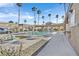 Community pool and hot tub surrounded by palm trees and lounge chairs at 3672 Angela Robin St # 206, Las Vegas, NV 89129