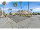 Entrance to a gated community with tall palm trees lining the street at 3672 Angela Robin St # 206, Las Vegas, NV 89129