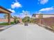 Wide backyard featuring concrete area with basketball hoop and landscaped surroundings at 380 Baratheon Ave, Las Vegas, NV 89183