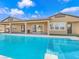 Spacious backyard featuring a sparkling pool with spa and outdoor living space at 380 Baratheon Ave, Las Vegas, NV 89183