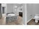 Modern bathroom showcasing tub, tiled floors, and toilet at 380 Baratheon Ave, Las Vegas, NV 89183
