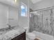 Bright bathroom with a granite countertop vanity and a combination bathtub and shower with stone-look surround at 380 Baratheon Ave, Las Vegas, NV 89183