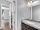 A bathroom with modern vanity, stone countertop, and adjacent shower at 380 Baratheon Ave, Las Vegas, NV 89183