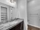 A modern bathroom featuring a marble countertop, vanity, and tiled flooring at 380 Baratheon Ave, Las Vegas, NV 89183