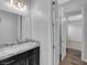 A bathroom with granite counters, modern lighting, and adjacent shower and bedroom at 380 Baratheon Ave, Las Vegas, NV 89183