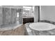 Elegant bathroom with large tub, tiled floors and marble counters at 380 Baratheon Ave, Las Vegas, NV 89183